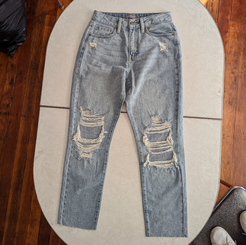 Distressed Mid Rise Raw Hem Light Wash Jeans